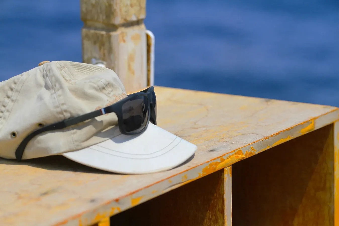 Pescador con gorra transpirable protegiéndose del sol junto a la orilla